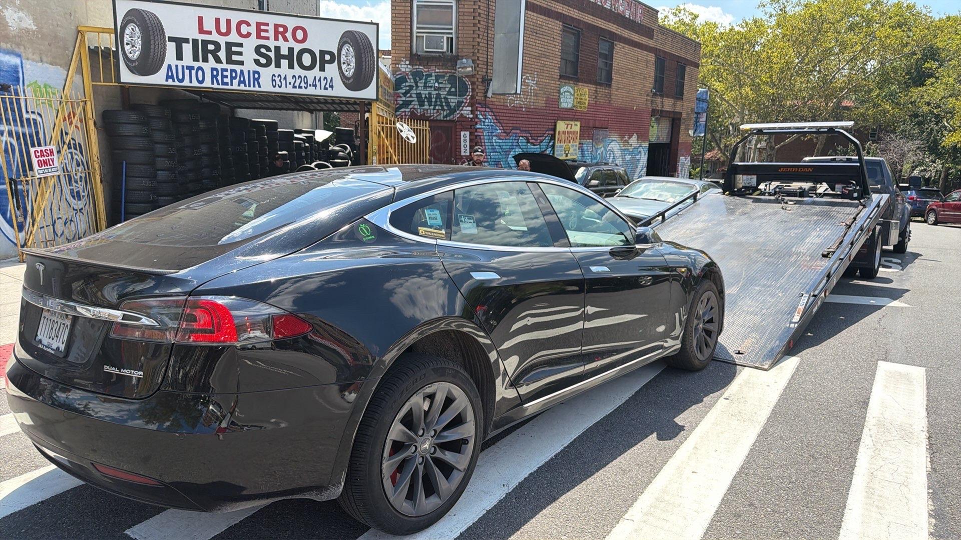 Tesla being flatbed towed by EV Towing NYC